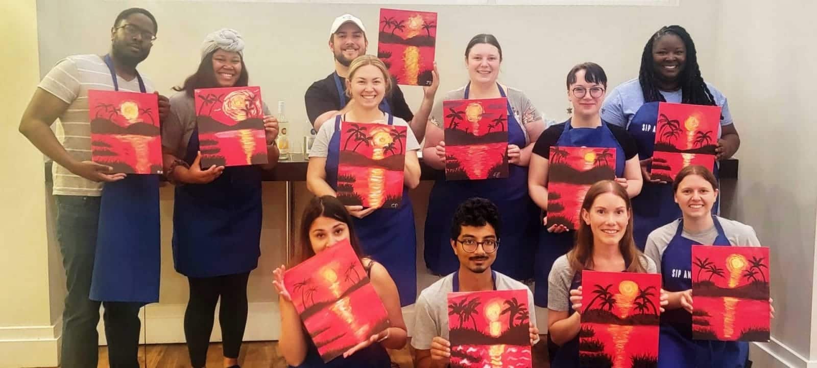 A group of people participating in a sip and paint event in DC.