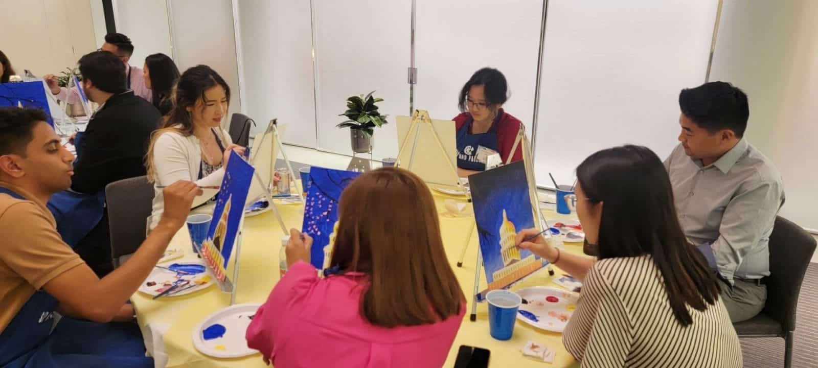 A group of people enjoying a paint and sip session in DC.