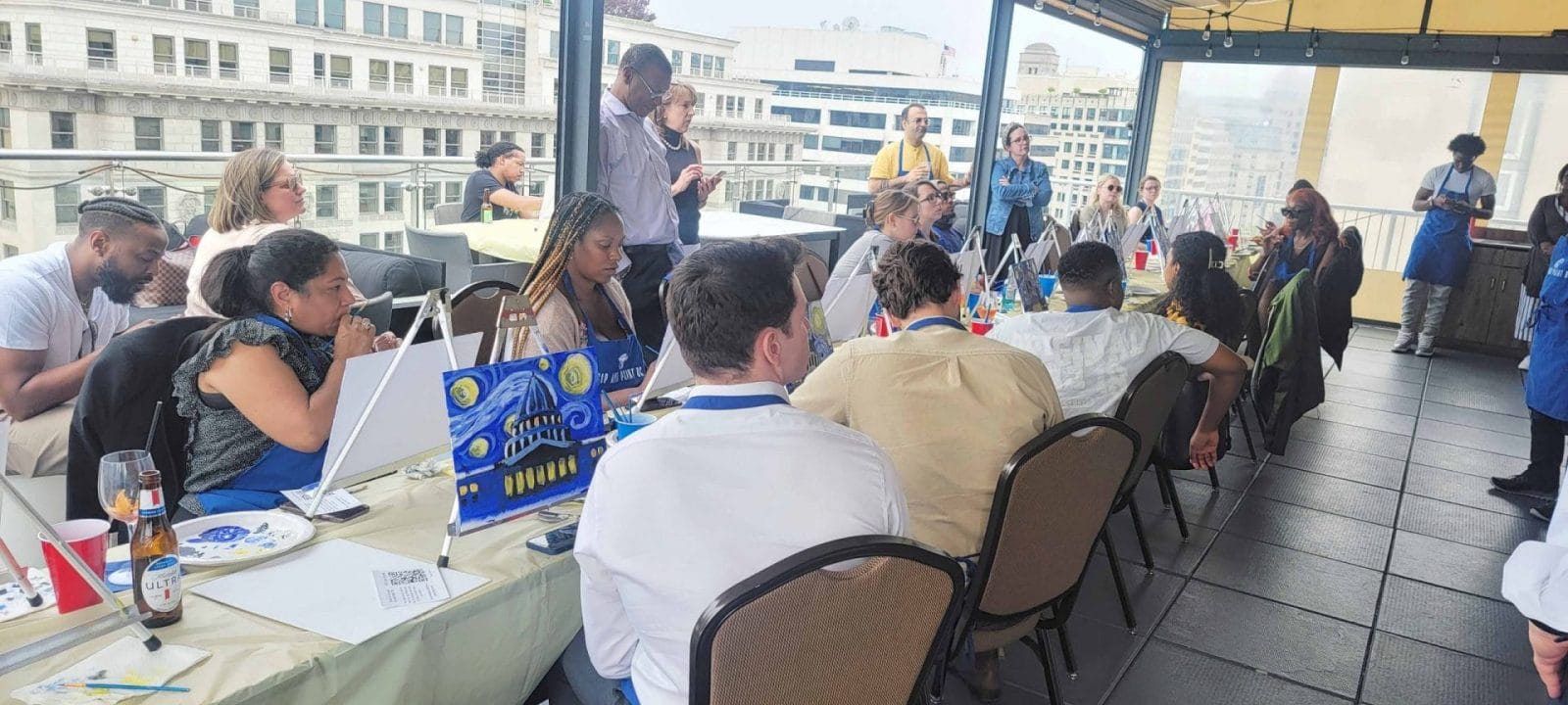 A group of people sipping and painting at a restaurant in DC.