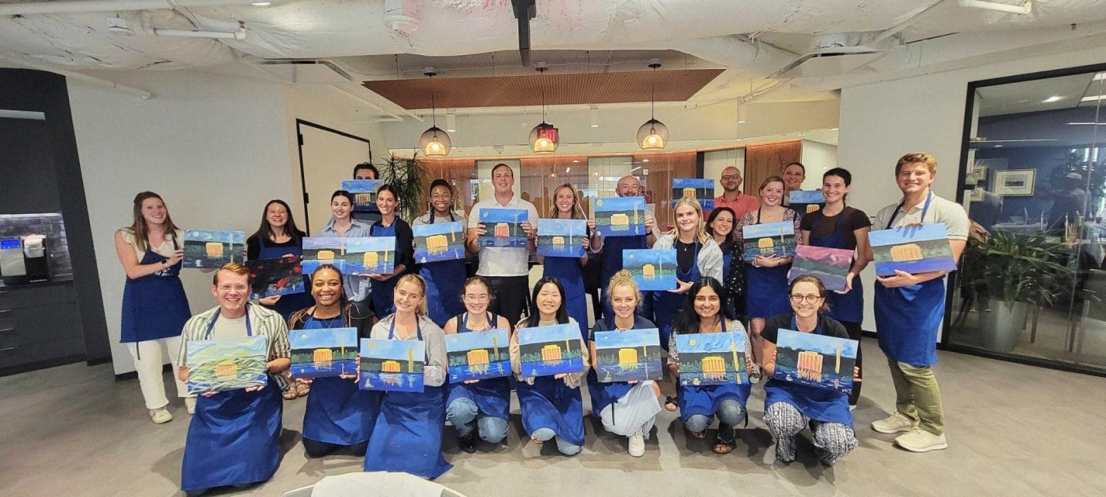 A group of people displaying paintings at the best paint and sip in DC.