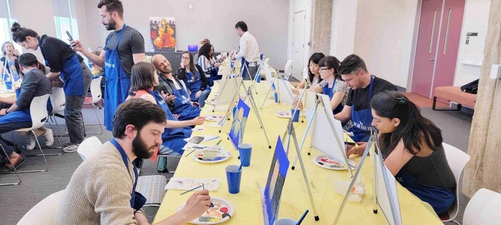 A nearby "paint and sip" gathering where individuals paint together at a table.
