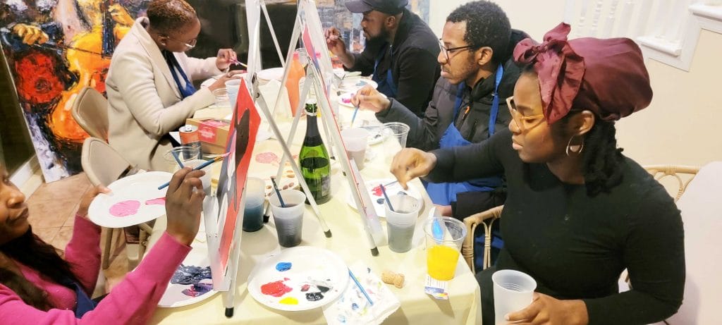 A group of people enjoying a paint and sip session in DC.