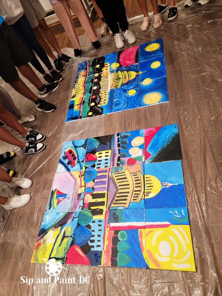 Participants stand around two collaborative mural paintings of the Capitol building during a Sip and Paint DC event. Each mural is composed of several individually painted tiles.