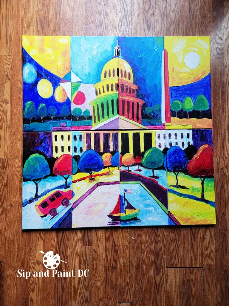 A colorful painting on wood flooring depicts a stylized Capitol building, Washington Monument, vibrant trees, a bus, and a sailboat. Branding on the bottom left reads "Sip and Paint DC.